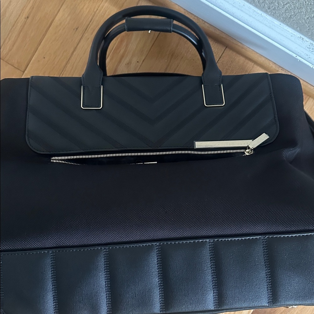 Ted Baker stylish, black travel bag with pull handle and wheels.